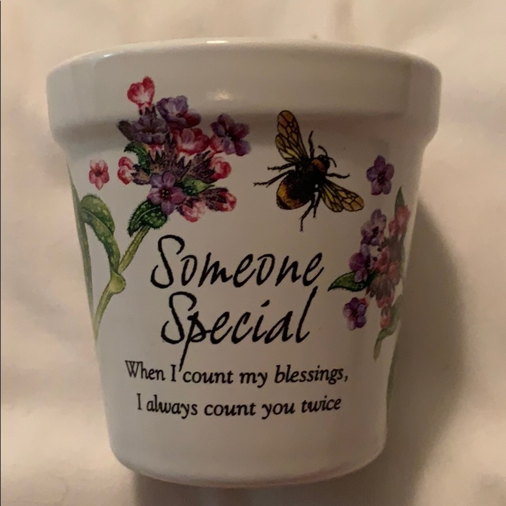 Stoneware pot with candle.